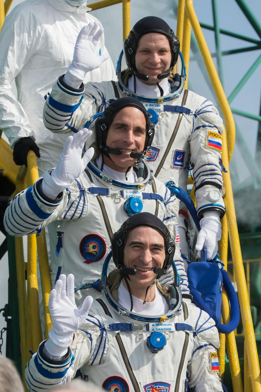 jsc2020e017122 - Expedition 63 Crew Waves Farewell - Expedition 63 crewmembers Ivan Vagner of Roscosmos, top, Chris Cassidy of NASA, center, and Anatoly Ivanishin wave goodbye as they prepare to climb aboard the Soyuz MS-16 rocket at Site 31 at the Baikonur Cosmodrome in Kazakhstan, Thursday, April 9, 2020. They launched a short time later to the International Space Station for the start of a six-and-a-half month mission. Photo Credit: (NASA/GCTC/Andrey Shelepin)