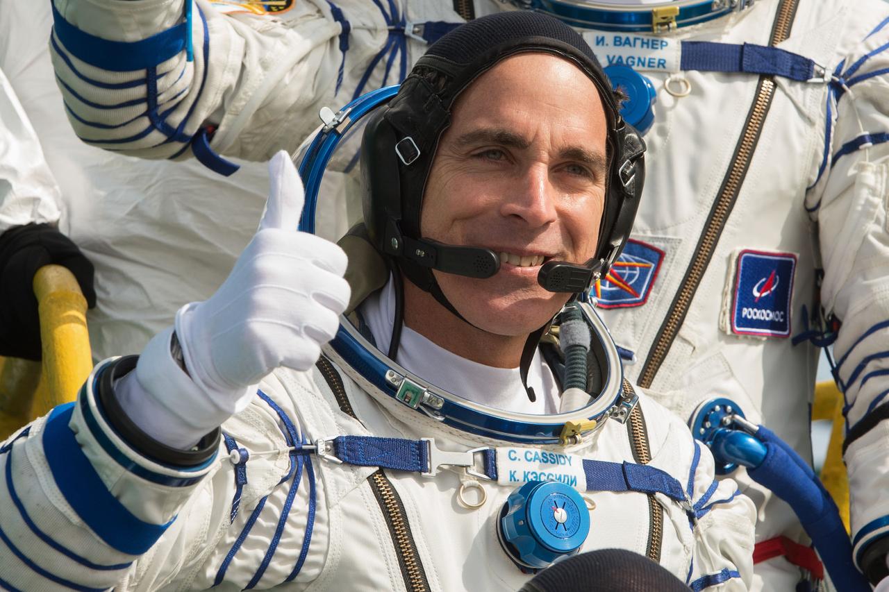 jsc2020e017124 - Expedition 63 Crew Waves Farewell - Expedition 63 crewmember Chris Cassidy of NASA waves goodbye as he, and cosmonauts Ivan Vagner and Anatoly Ivanishin of Roscosmos, prepare to climb aboard the Soyuz MS-16 rocket at Site 31 at the Baikonur Cosmodrome in Kazakhstan, Thursday, April 9, 2020. They launched a short time later to the International Space Station for the start of a six-and-a-half month mission. Photo Credit: (NASA/GCTC/Andrey Shelepin)