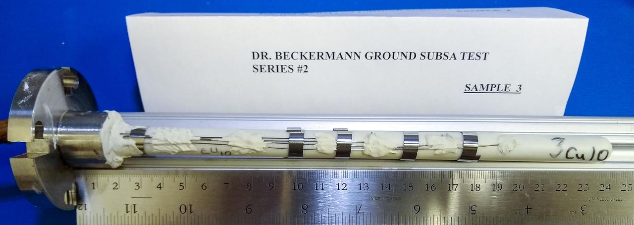 jsc2020e017722 (3/30/2020) --- A preflight view of an Alumina ampoule containing an Al-10%Cu alloy sample. The thermocouple wires are secured to the outside of the ampoule with refractory bonding material, while the metal clips provide additional support.