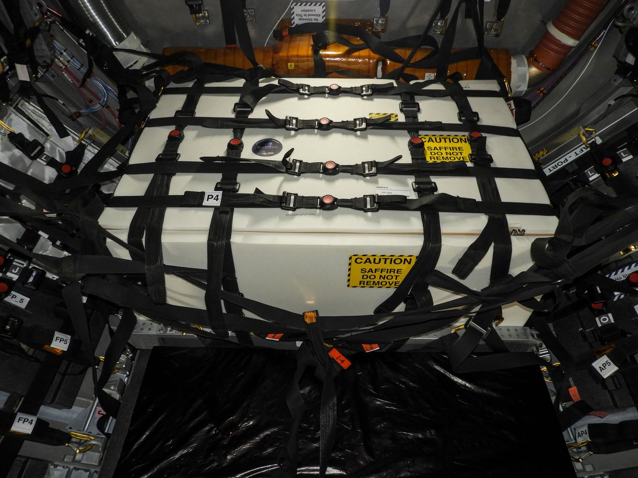 jsc2020e043815 (Sept. 10, 2020) --- A view of the Spacecraft Fire Safety Experiments (Saffire) V experiment hardware, loaded inside the Northrop Grumman(NG) Cygnus cargo vehicle for the 14th NG resupply mission to the International Space Station. Saffire is a series of experiments to investigate how fire spreads on a variety of combustible materials in the microgravity environment. The experiments are ignited in Cygnus cargo spacecraft after it departs the space station and before it reenters the Earth's atmosphere. Studying the development and growth of fire in a re-supply cargo vehicle eliminates the risk of exposure to humans in an occupied spacecraft. Understanding how fire behaves in microgravity, and how different materials propagate flames in space is immensely important for the development of future crew spacecraft.