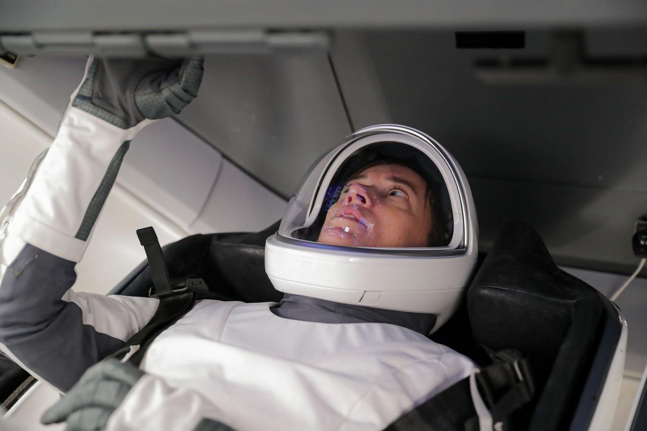 jsc2021e007020 (Jan. 7, 2021) --- NASA astronaut Megan McArthur, pilot for the SpaceX Crew-2 mission to the International Space Station, is seated inside a mockup of the SpaceX Crew Dragon vehicle during a training session at the SpaceX training facility in Hawthorne, California. Credit: SpaceX