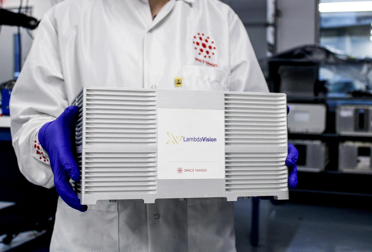 jsc2021e007776 (2/5/2021) --- Researchers move the CubeLab that contains a new LambdaVision investigation, Characterization of the Function and Stability of Bacteriorhodopsin Following Exposure to a Microgravity Environment (Protein-Based Artificial Retina Manufacturing). Protein-Based Artificial Retina Manufacturing evaluates a manufacturing system that uses a light-activated protein that replaces the function of damaged cells in the eye. Image courtesy of LambdaVision.