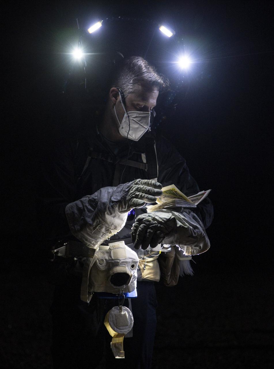 Date: 03-02-2021 Location: JSC Rockyard Subject: Scott Wray rewiews test documents during Lunar Exploration EVA Night Operations at Johnson Space Center's Rock Yard. Photographer: James Blair 
