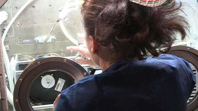 jsc2021e012558 (12/2021) --- NASA astronaut Shannon Walker, handling the fiber produced by the second iteration of FOP hardware (FOP1.5) during the ISS demo in December 2020. Image courtesy of Physical Optics Corporation.