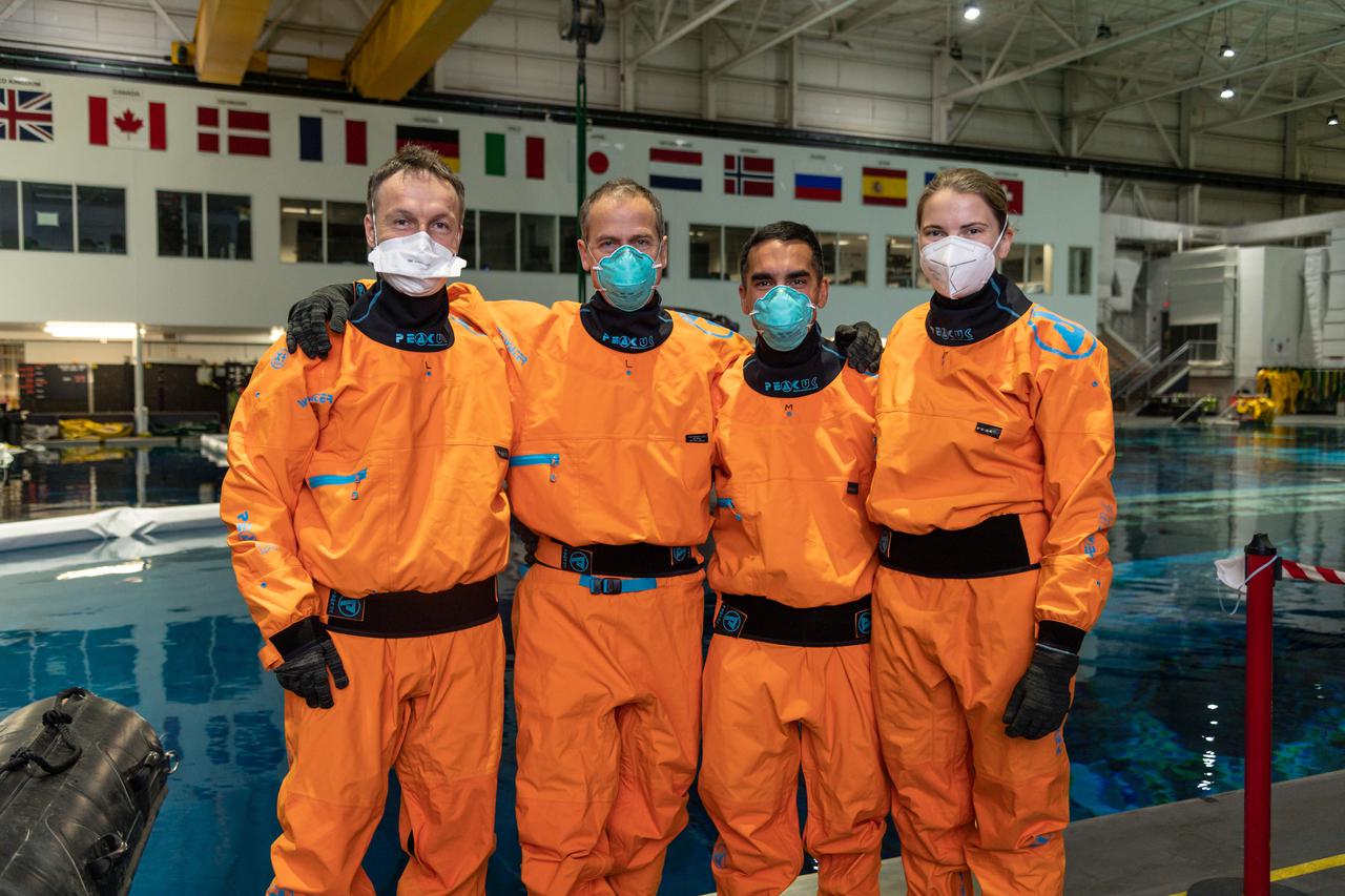 jsc2021e017093 (April 30, 2021) --- SpaceX Crew-3 astronauts (from left) Matthias Maurer, Tom Marshburn, Raja Chari and Kayla Barron pose for a portrait during water survival training at the Neutral Buoyancy Laboratory at NASA's Johnson Space Center in Houston, Texas.