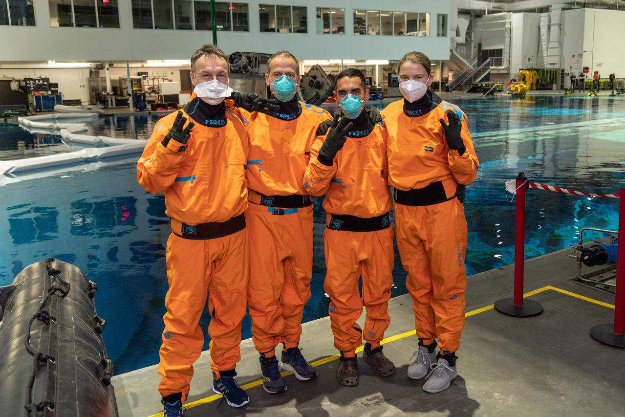 jsc2021e017095 (April 30, 2021) --- SpaceX Crew-3 astronauts (from left) Matthias Maurer, Tom Marshburn, Raja Chari and Kayla Barron pose for a portrait during water survival training at the Neutral Buoyancy Laboratory at NASA's Johnson Space Center in Houston, Texas.