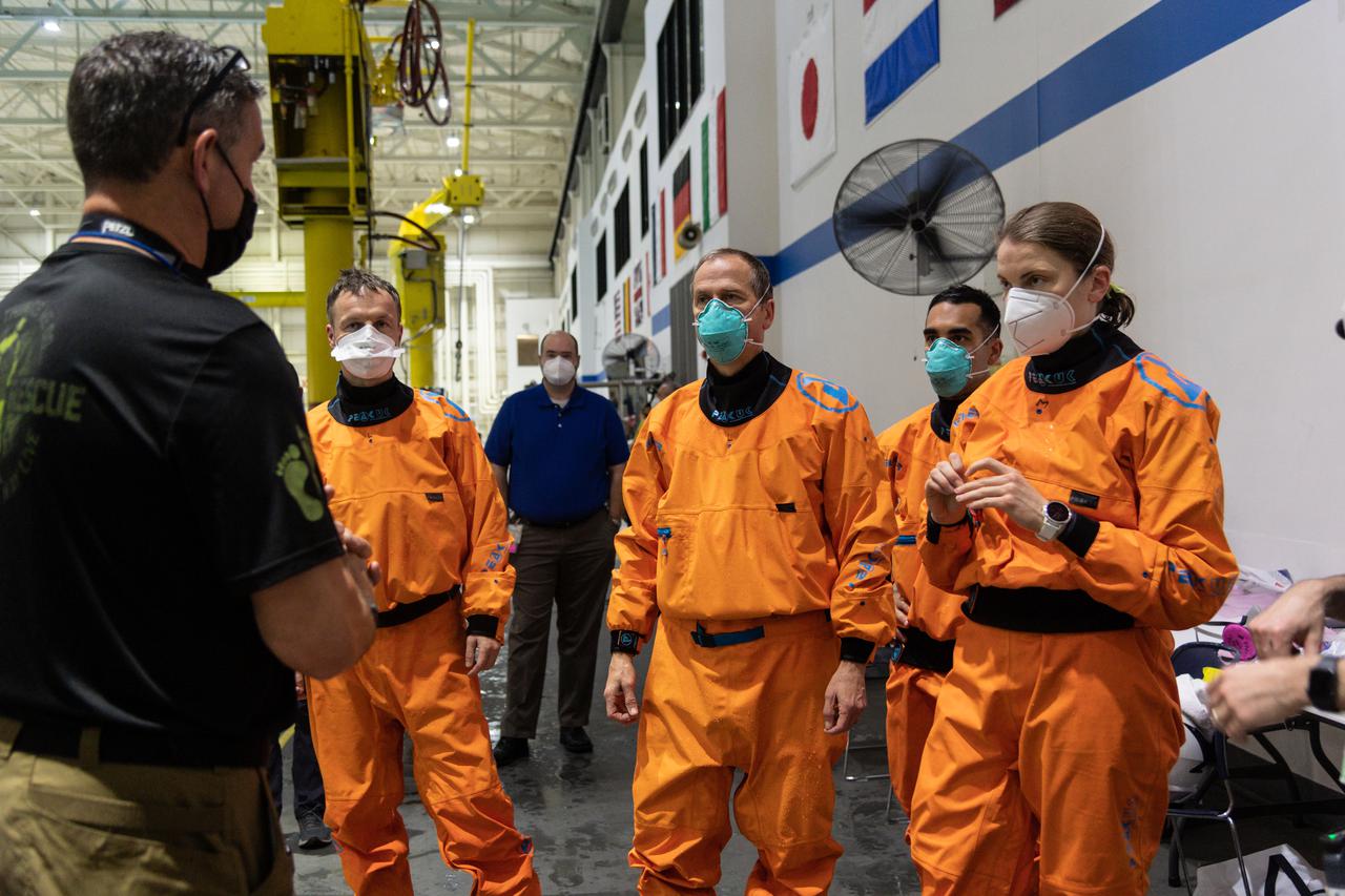 jsc2021e017162 (April 30, 2021) --- SpaceX Crew-3 astronauts (from left) Matthias Maurer, Tom Marshburn, Raja Chari and Kayla Barron, and support personnel participate in water survival training at the Neutral Buoyancy Laboratory at NASA's Johnson Space Center in Houston, Texas.