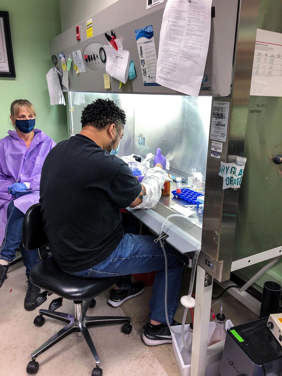 jsc2021e019395 (5/19/2021) ---  Stefanie Countryman (Director, Bioserve), and Kendan Jones (UW) prepare media cassettes during system testing. Effects of Microgravity on the Structure and Function of Proximal and Distal Tubule MPS (Kidney Cells-02) uses a 3D kidney cell model or chip to study the effects of microgravity on formation of microcrystals in kidney tubules. Image courtesy of Cathy Yeung (UW School of Pharmacy).