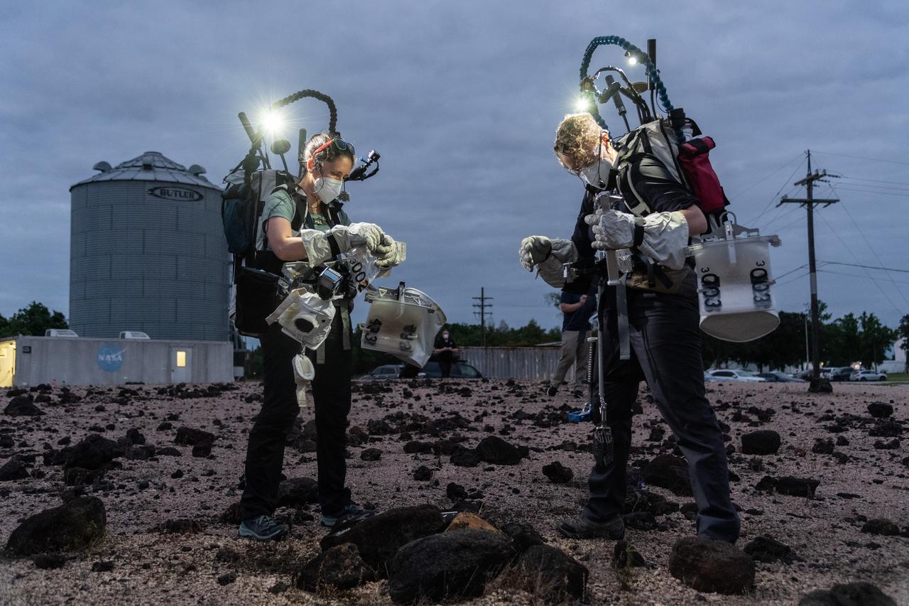 Test subjects Kelsey Young and Tess Caswell evaluate lunar field geology tasks as part of the Exploration Extravehicular Activity (xEVA) night operations development tests conducted at Johnson Space Center’s Rock Yard.