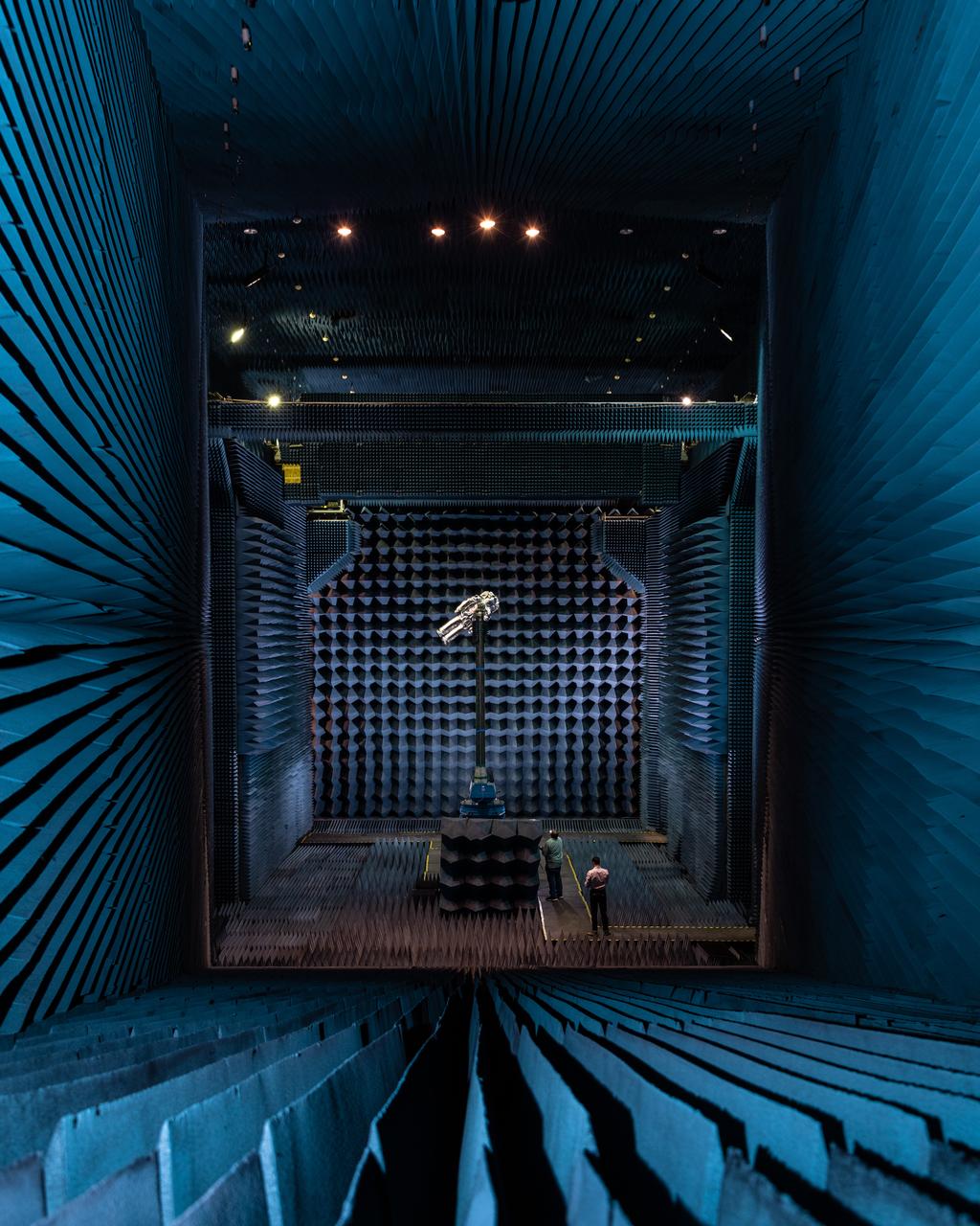 xEMU Antenna testing being performed in the B14 Anechoic Chamber to inspect MLI keep out zones for the antennas. The xEMU Test article is named xGUS, the successor to the EMU Test Article also named GUS (named after Gus Grissom and his iconic silver spacesuit). Image taken from where "horn" is located that sends out radio frequency signals for test. Photographer: Norah Moran – Johnson Space Center