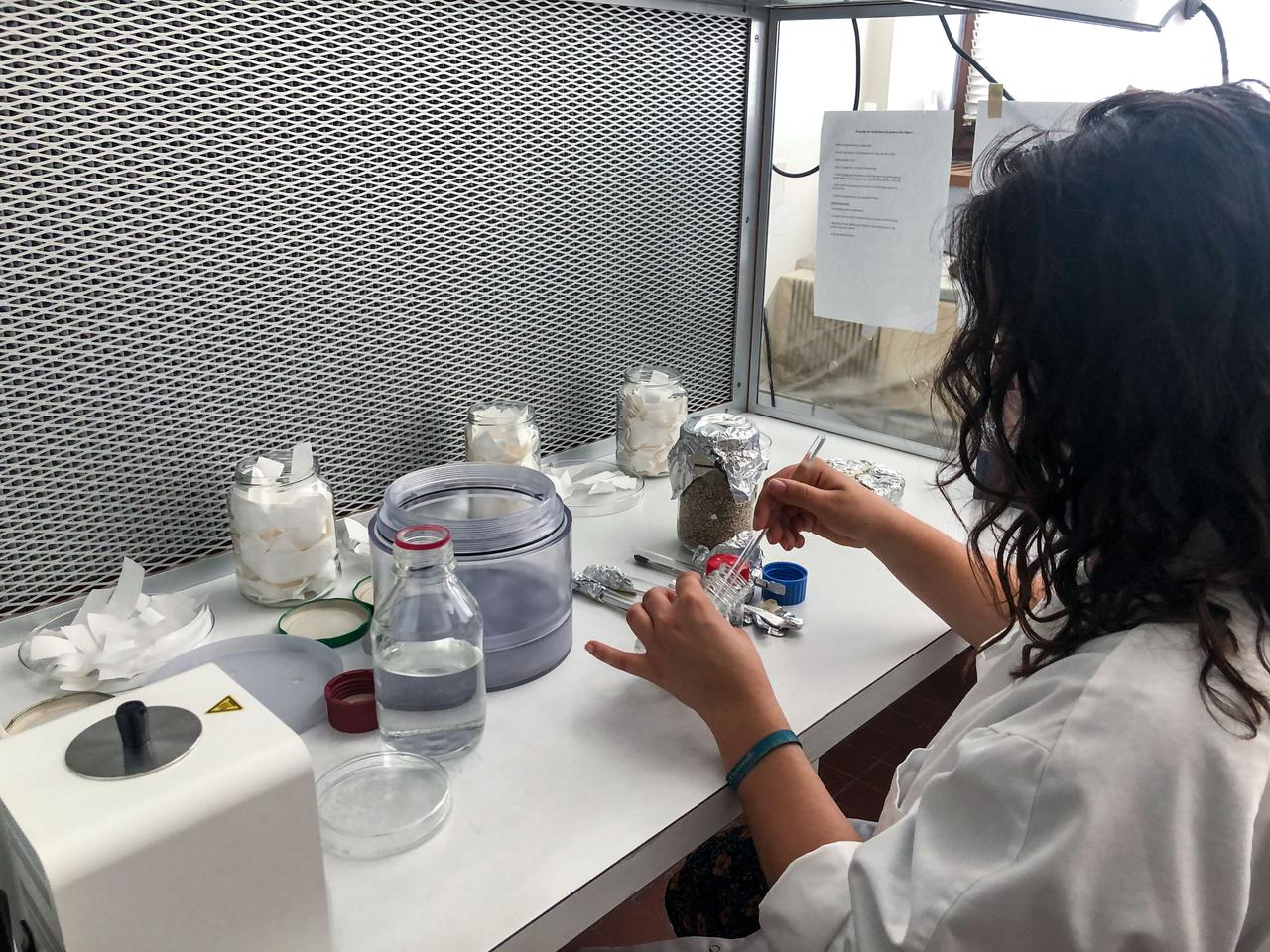 jsc2021e029977 (9/11/2020) --- A preflight biology test on the QM. Eve Teyssier (on the picture) is assembling the pot of the Eklosion capsule under sterile condition. The Eklosion investigation consist of a vase that is utilized by a crew member to grow a Marigold flower (Tagetes patula) aboard the ISS. The investigation takes place at the leisure of the crew member and helps to study the process of plant growth in space, as well as using a personally tended house plant in space to help establish a psychological link between the crew member aboard the ISS and Earth. Image courtesy of Eklo association.