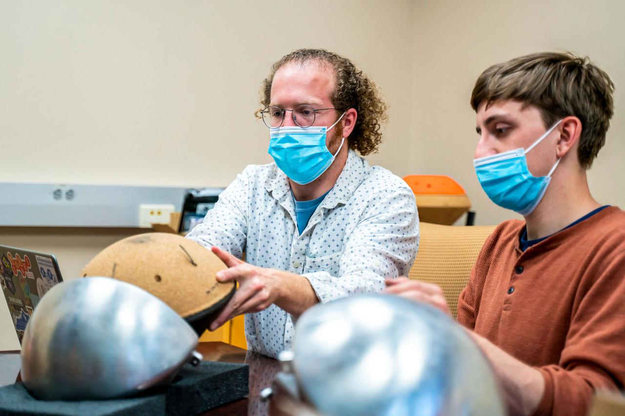 jsc2021e031159 (7/22/2021) --- John Schmidt, graduate student and mechanical engineering lead and Matthew Ruffner, graduate student and electrical engineering lead of KREPE. The Kentucky Re-Entry Probe Experiment (KREPE) demonstrates an affordable technology for re-entry experiments and provides flight data on Thermal Protection Systems (TPS) to help validate computational models.  Photo courtesy of the University of Kentucky.