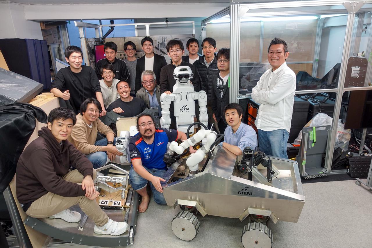 jsc2021e036655 (8/11/2021) --- The GITAI team. The GITAI S1 Robotic Arm Tech Demo (Nanoracks-GITAI Robotic Arm) demonstrates the versatility and dexterity in microgravity of a robot designed by GITAI Japan Inc. For the demonstration, the robot conducts common crew activities and tasks via supervised autonomy and teleoperations from the ground.