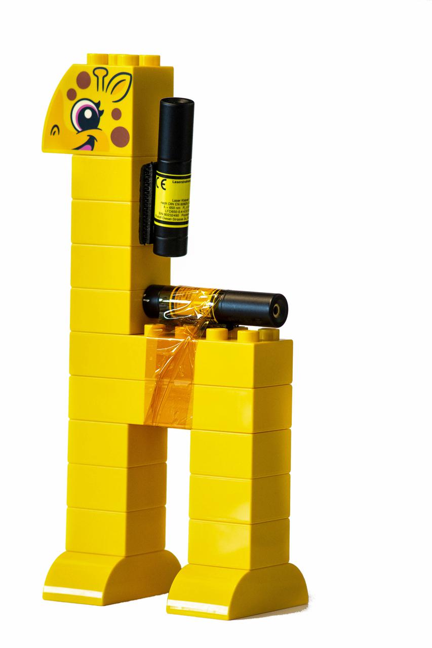 jsc2021e037884 (4/19/2021) --- A preflight photo of the Lego Duplo giraffe with two laser-pointers as the second object to be observed rotating around its intermediate axis for the Dzhanibekov Demonstrations investigation. Image courtesy of DLR.