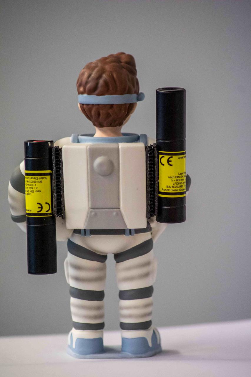 jsc2021e037886 (3/5/2021) --- A preflight photo of the Little Major Tom figure with two laser-pointers as the third object to be observed rotating around its intermediate axis for the Dzhanibekov Demonstrations investigation. Image courtesy of DLR.