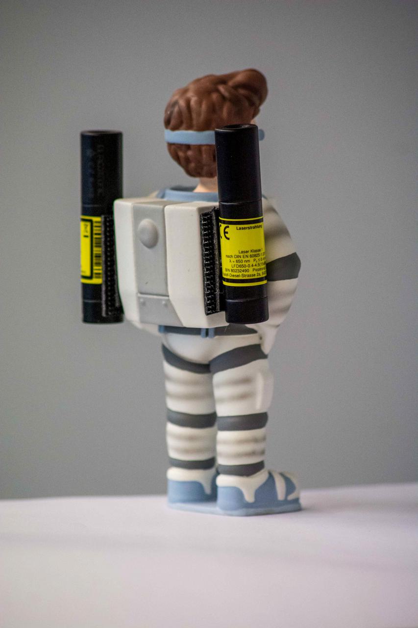 jsc2021e037887 (3/5/2021) --- A preflight photo of the Little Major Tom figure with two laser-pointers as the third object to be observed rotating around its intermediate axis for the Dzhanibekov Demonstrations investigation. Image courtesy of DLR.