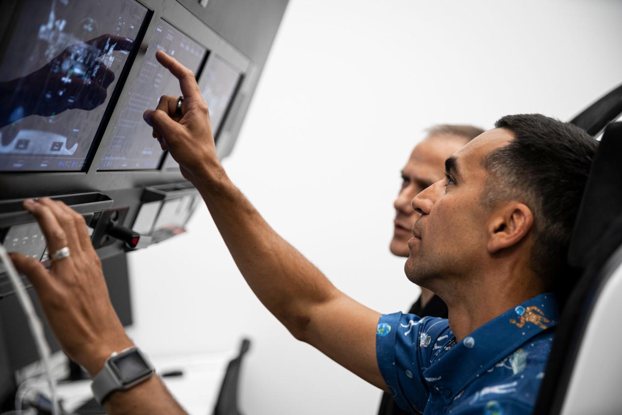jsc2021e038356 (May 18, 2021) --- The pilot and commander for the SpaceX Crew-3 mission, NASA astronauts Thomas Marshburn (background) and Raja Chari, are pictured during preflight training at SpaceX headquarters in Hawthorne, California. Credit: SpaceX