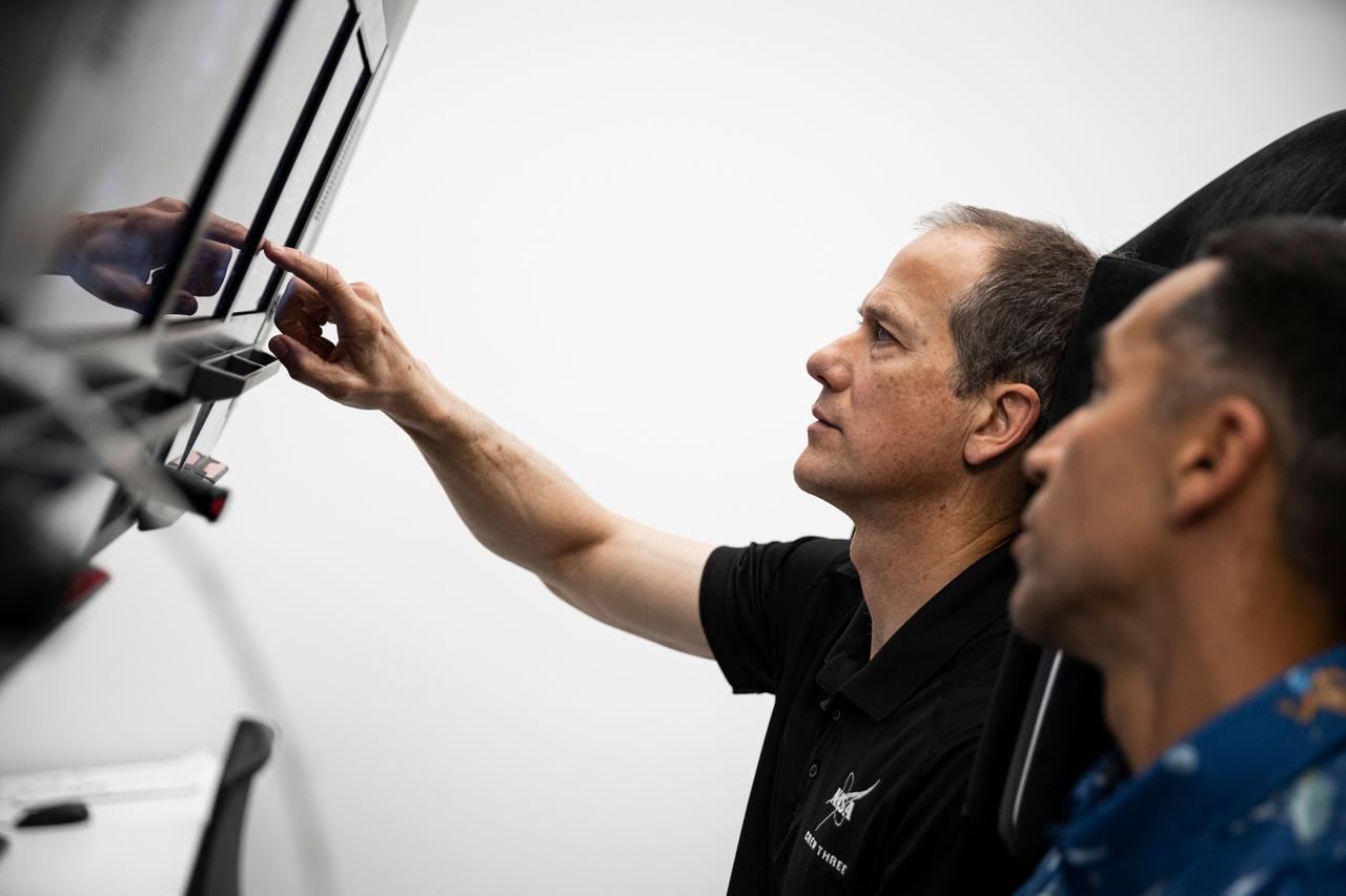 jsc2021e038357 (May 18, 2021) --- The pilot and commander for the SpaceX Crew-3 mission, NASA astronauts Thomas Marshburn (background) and Raja Chari, are pictured during preflight training at SpaceX headquarters in Hawthorne, California. Credit: SpaceX