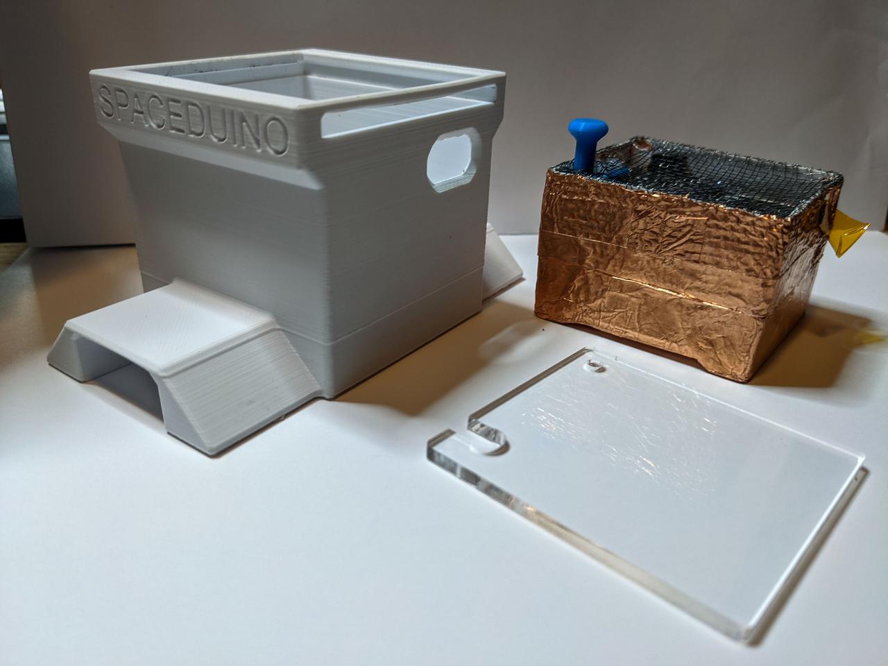 jsc2021e044614 (6/22/2021) --- A view of the SpaceDuino Qualification Unit prior to final assembly. The electronics are packed inside a Faraday cage to mitigate Electro-Magnetic Interference. The 3D printed enclosure and laser-cut acrylic window protect the unit during launch loads and in use.  Image courtesy of Bryan Murphy.