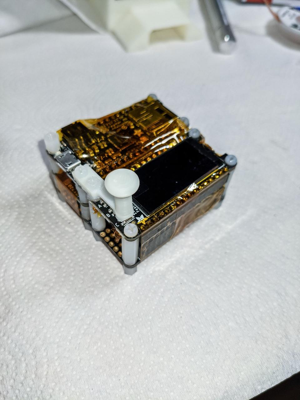 jsc2021e044615 (7/5/2021) --- A preflight view of the electronics of a SpaceDuino development unit which are assembled and ready to drop into the 3D printed enclosure. The button plunger (white) is 3D printed as well. Image courtesy of Bryan Murphy.