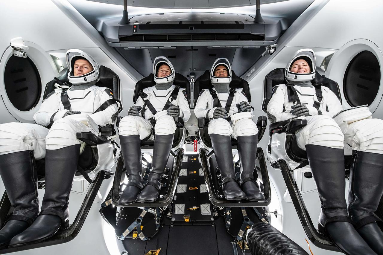 jsc2021e046404 (Oct. 9, 2021) --- The astronauts of SpaceX Crew-3 pose for a portrait in their suits during a training session inside the SpaceX Crew Dragon spacecraft. From left are, ESA (European Space Agency) astronaut Matthias Maurer and NASA astronauts Raja Chari, Thomas Marshburn and Kayla Barron. Chari is Commander, Marshburn is the Pilot and Barron and Maurer are both Mission Specialists. Credit: SpaceX