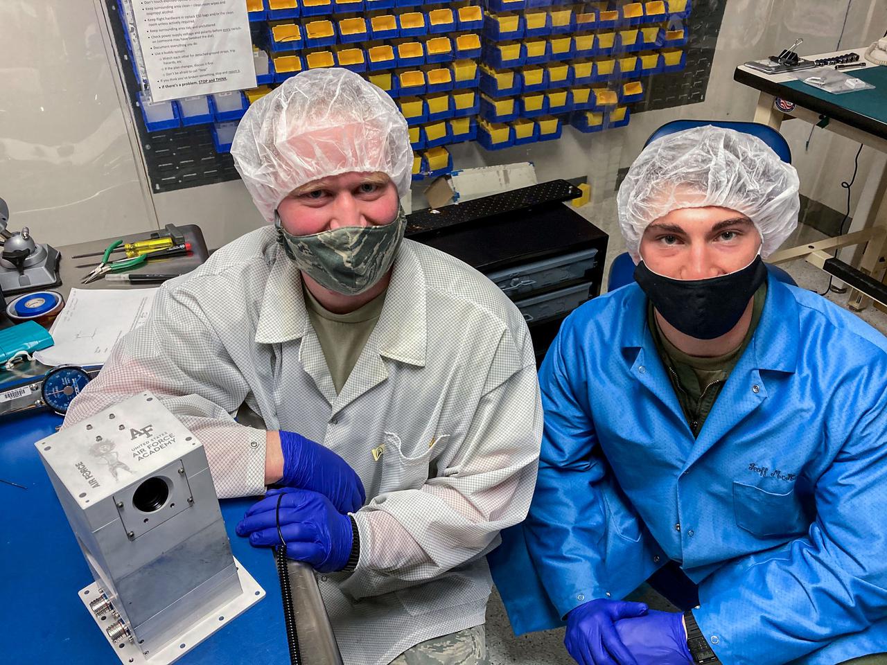 jsc2021e048047 (2/19/2021) --- Captain Hayden Richards (left) and Cadet Madison Yates (Right) with the flight unit of Falcon Neuro. Lightning and sprites are related forms of electrical discharges in Earth’s atmosphere. Space Test Program-Houston 7-Falcon Neuro (STP-H7-Falcon Neuro) demonstrates using event-based sensors (EBSs) to detect lightning in cloud tops and electrical discharges in the middle atmosphere. EBSs provide the high-speed optical sensing needed to capture such brief phenomena and data rates fast enough for making these observations from space. This technology could improve understanding of atmospheric electrical phenomena. Image courtesy of United States Air Force Academy.