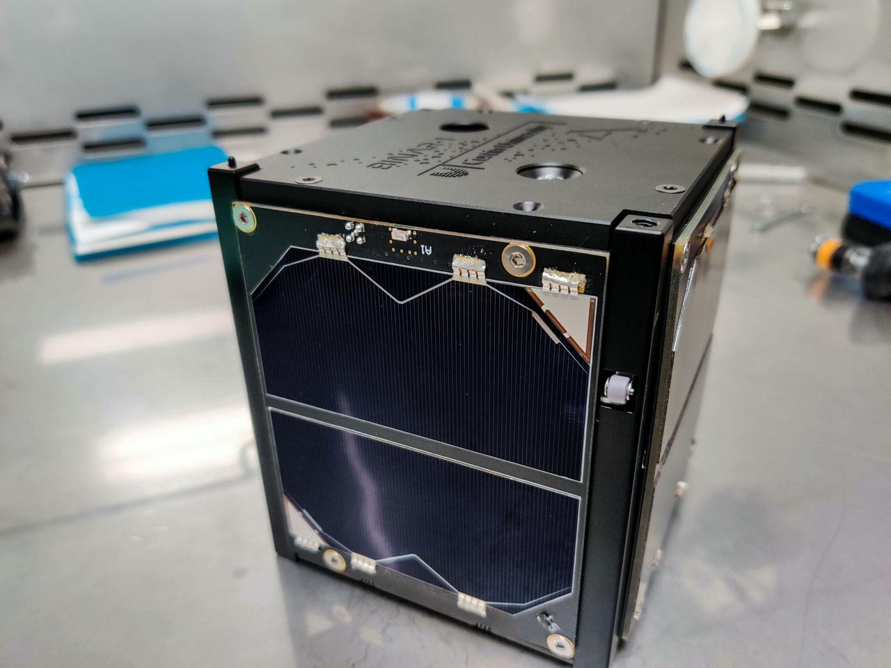 jsc2021e052200 (1/25/2021) ---  A completed Binar-1 flight model sits waiting for launch. Binar-1 is first Western Australian sovereign spacecraft. The deep blue solar panels seen at the front of the spacecraft will power the two sunken camera lenses seen on the top of the satellite, amongst a plethora of other subsystems. Binar-1 is a 1-Unit (1U) CubeSat, the first in a series from Curtin University in Perth, Australia, to help establish a capability for planetary research. The satellite is developed by a team of students and researchers with the intention to cultivate the skills and technology to build future planetary missions focused on the Moon and small bodies of the solar system.  Image courtesy of Curtin University.