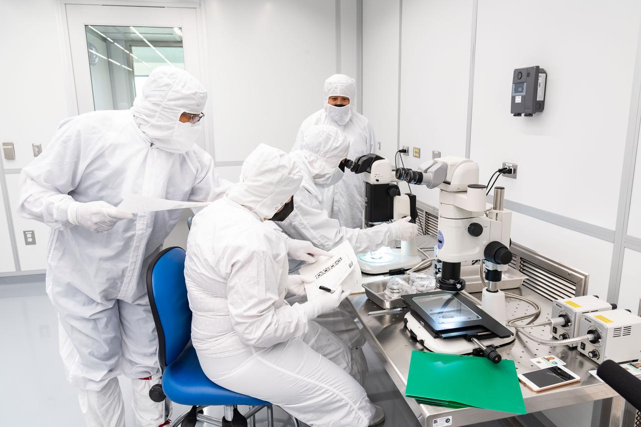 Scientists in the Astromaterials Research and Exploration Science (ARES) Division at NASA’s Johnson Space Center study samples retrieved by the Japan Aerospace Exploration Agency’s (JAXA) Hayabusa2 spacecraft and returned to Earth in late 2020.  JAXA shared a portion of the samples with NASA, and in exchange, NASA will provide JAXA a percentage of a sample of asteroid Bennu, when the agency’s OSIRIS-REx spacecraft returns to Earth from the space rock in 2023. Photo Date: November 30, 2021. Location: Bldg. 31, H2 Clean Room.  Photographer: Robert Markowitz