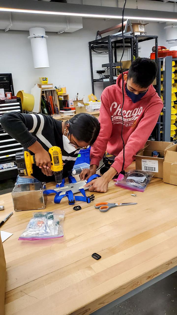 jsc2021e063273--Mechanical Engineering team assembling mounting plate in the Makerspace From left to right: Kalpana Ganeshan, Gaurav Kulkarni Image courtesy of Alfonso Ussia