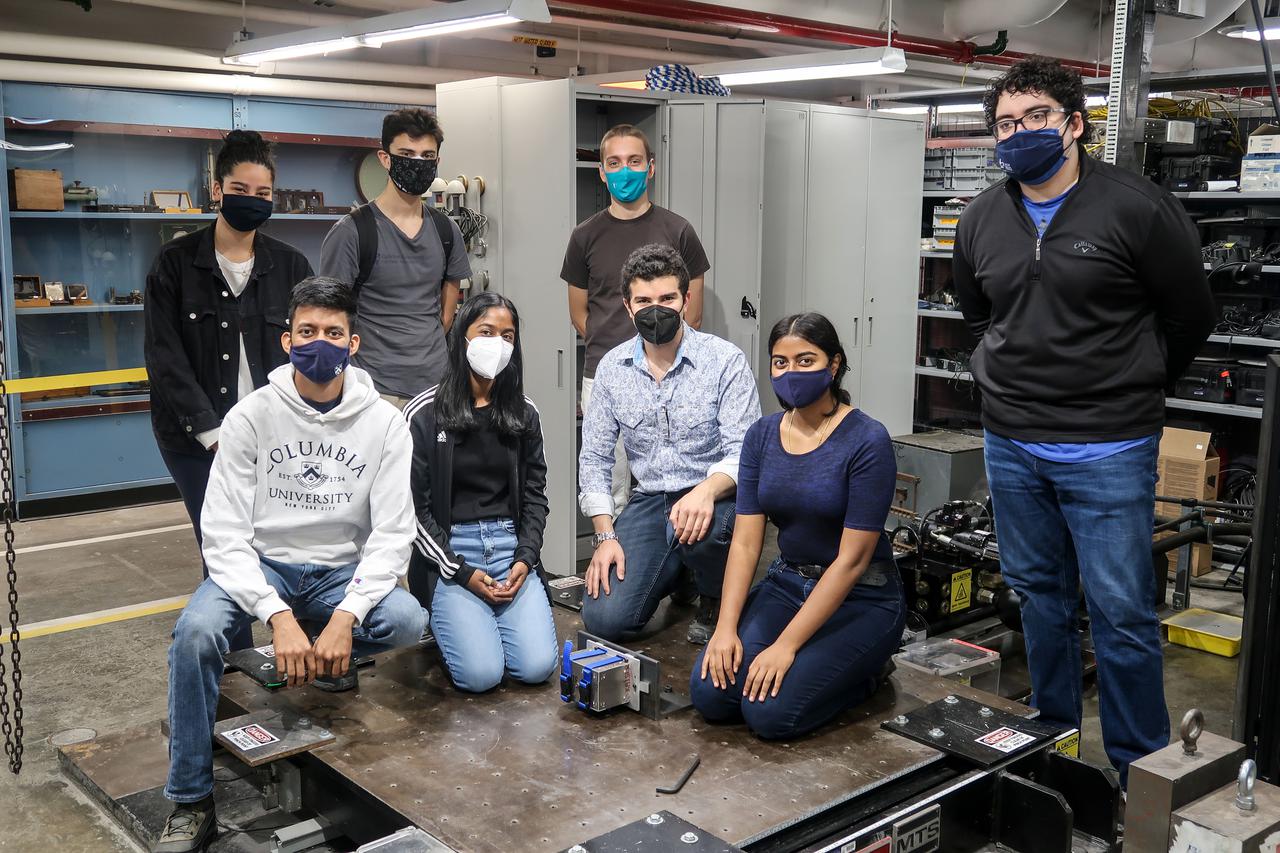 jsc2021e063276--Team members pictured alongside payload at Carleton Laboratory, where the payload’s structural integrity is tested. From left bottom to right bottom: Gaurav Kulkarni, Kalpana Ganeshan, Alfonso Ussia, Swati Ravi From left top to right top: Deanna Duqmaq, Juan Zuniga, Pol Bernat, Hugo Favila Image courtesy of Jane Nisselson