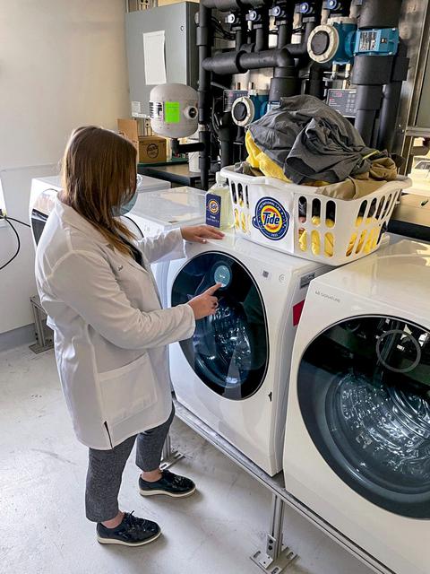 jsc2021e064546 (11/30/2021) --- Jessica Zinna, Tide Scientist at P&G, prepares a load of laundry that will be washed in Tide’s laundry detergent solution for P&G Telescience Investigation of Detergent Experiments (PGTIDE). The detergent will be on board SpaceX CRS-24. Following the signing of a Space Act Agreement with NASA, Tide is developing a detergent solution for space that will aid in planned space travel such as the Artemis Moon missions and a crewed roundtrip Mars mission.  Image courtesy of P&G.