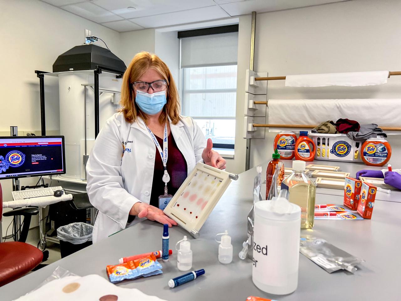 jsc2021e064548 ()11/30/2021) --- In support of P&G Telescience Investigation of Detergent Experiments (PGTIDE), Kristi Niehaus, Tide Scientist, Strategic Innovation & Technology at P&G, displays a stain set that will be used to test Tide detergent solutions on board the International Space Station National Labs in 2022 P&G Telescience Investigation of Detergent Experiments (PGTIDE). Following the signing of a Space Act Agreement with NASA, Tide is developing a detergent solution for space that will aid in planned space travel such as the Artemis Moon missions and a crewed roundtrip Mars mission.  Image courtesy of P&G.