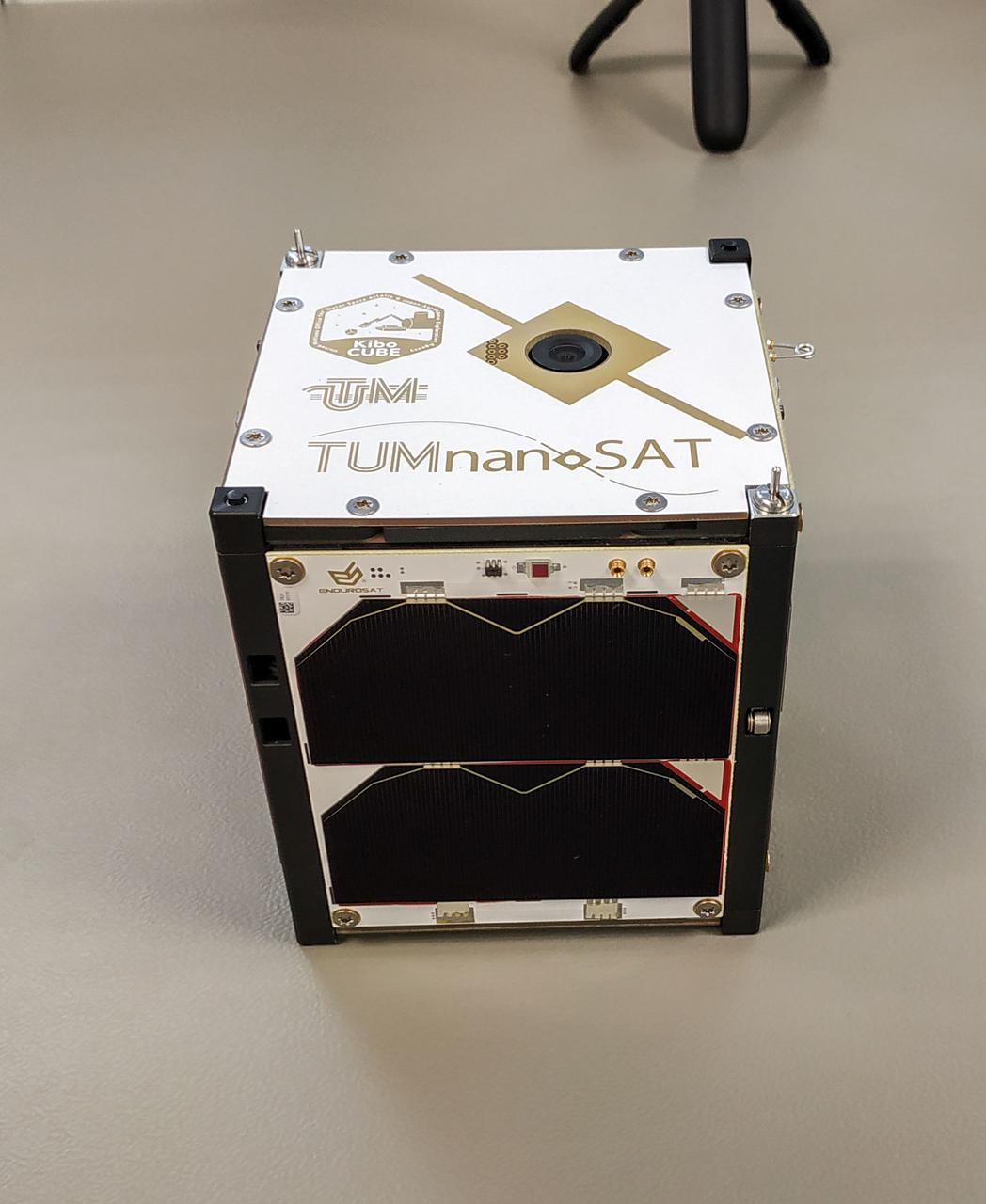 jsc2022e031228 (6/28/2021) --- A preflight view of the TUMnanoSAT satellite. TUMnanoSAT is an educational Cubesat developed at Technical University of Moldova to improve the quality of engineering studies in the Republic of Moldova and attract young students to develop and strengthen scientific research skills in space exploration. Image Credit: Technical University of Moldova