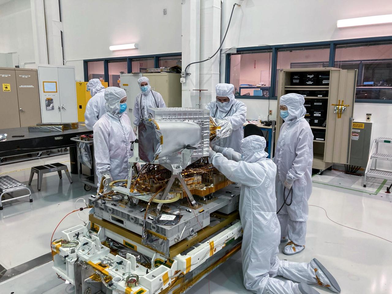 jsc2022e042616 (5/20/2022) --- The EMIT instrument before the enclosure panels were attached. The long tube in the foreground is the EMIT telescope baffle. The telescope resides in the large aluminum cube behind the baffle, and the spectrometer assembly is attached to the back of the telescope. The entire assembly is called the Optical Bench Assembly, or OBA. The OBA sits above the Electronics Mounting Plate, which is home to all of the instrument electronics and the cryocooler (not visible). Image courtesy of JPL.