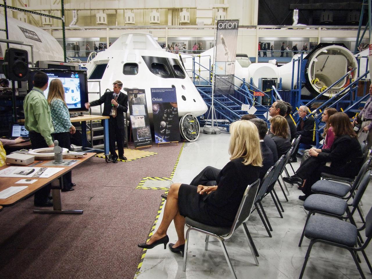 Jeff Fox, Christie Sauers, and Phillip Reyes present the Students Shaping America's Next Spacecraft (SSANS) program to NASA center directors in front of the Orion mockup in Building 9 at Johnson Space Center in Houston on Nov. 10, 2011. Part of Batch image transfer from Flickr.