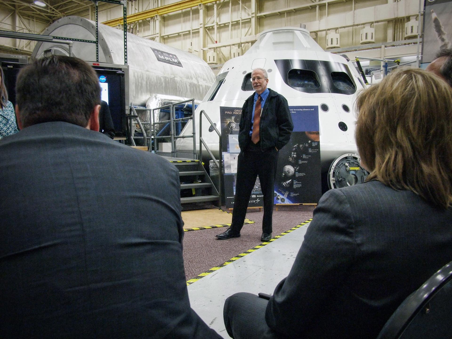 Orion Program Manager Mark Geyer stands in front of the Orion medium fidelity mockup in Building 9 at Johnson Space Center in Houston on Nov. 10, 2011.