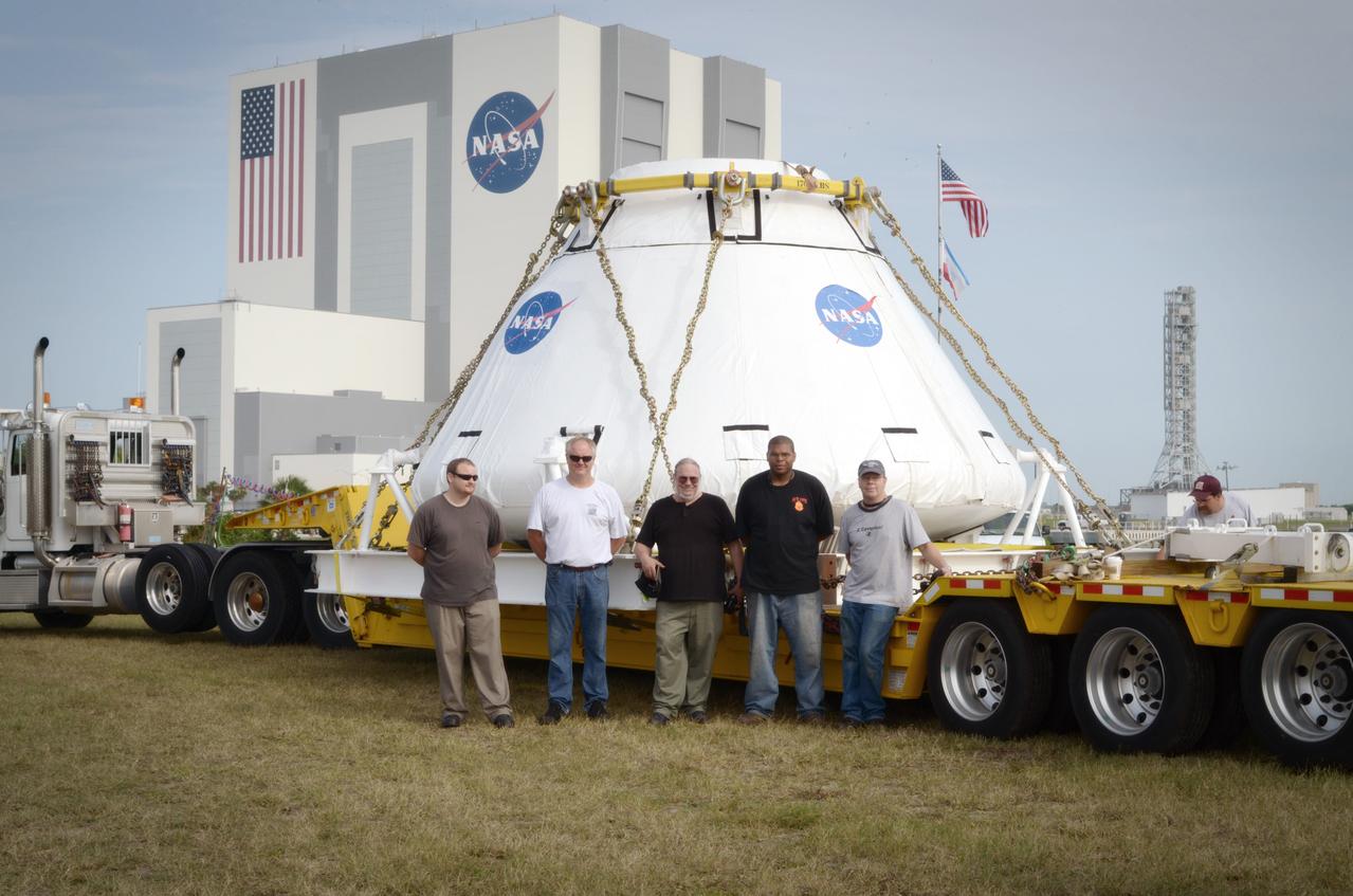 The Orion Pad Abort-1 (PA-1) crew module operations team poses with the crew module prior to its move to the Operations &amp; Checkout (O&amp;C) Building at Kennedy Space Center in Florida on July 11, 2011. Part of Batch image transfer from Flickr.