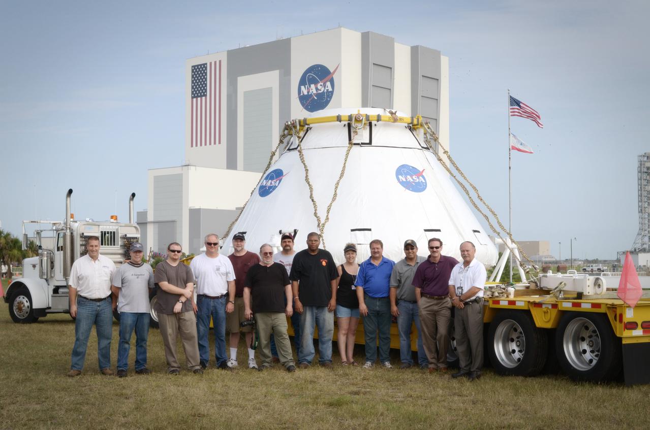 The Orion Pad Abort-1 (PA-1) crew module operations team poses with the crew module prior to its move to the Operations &amp; Checkout (O&amp;C) Building at Kennedy Space Center in Florida on July 11, 2011.  Part of Batch image transfer from Flickr.