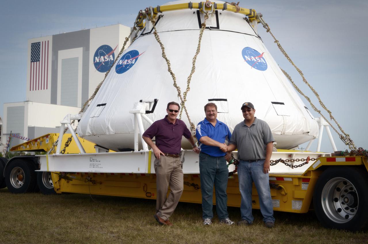 Dave McAllister, Wayne Hicks, and Gabe Baca pose in front of the Orion Pad Abort-1 (PA-1) crew module prior to its move to the Operations &amp; Checkout (O&amp;C) Building at Kennedy Space Center in Florida on July 11, 2011.  Part of Batch image transfer from Flickr.