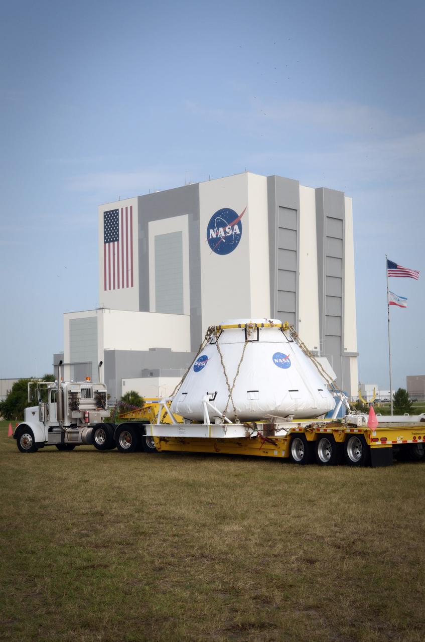The Orion Pad Abort-1 (PA-1) crew module pauses in front of the Vehicle Assembly Building (VAB) prior to the move to the Operations &amp; Checkout (O&amp;C) building at Kennedy Space Center in Florida on July 11, 2011.  Part of Batch image transfer from Flickr.