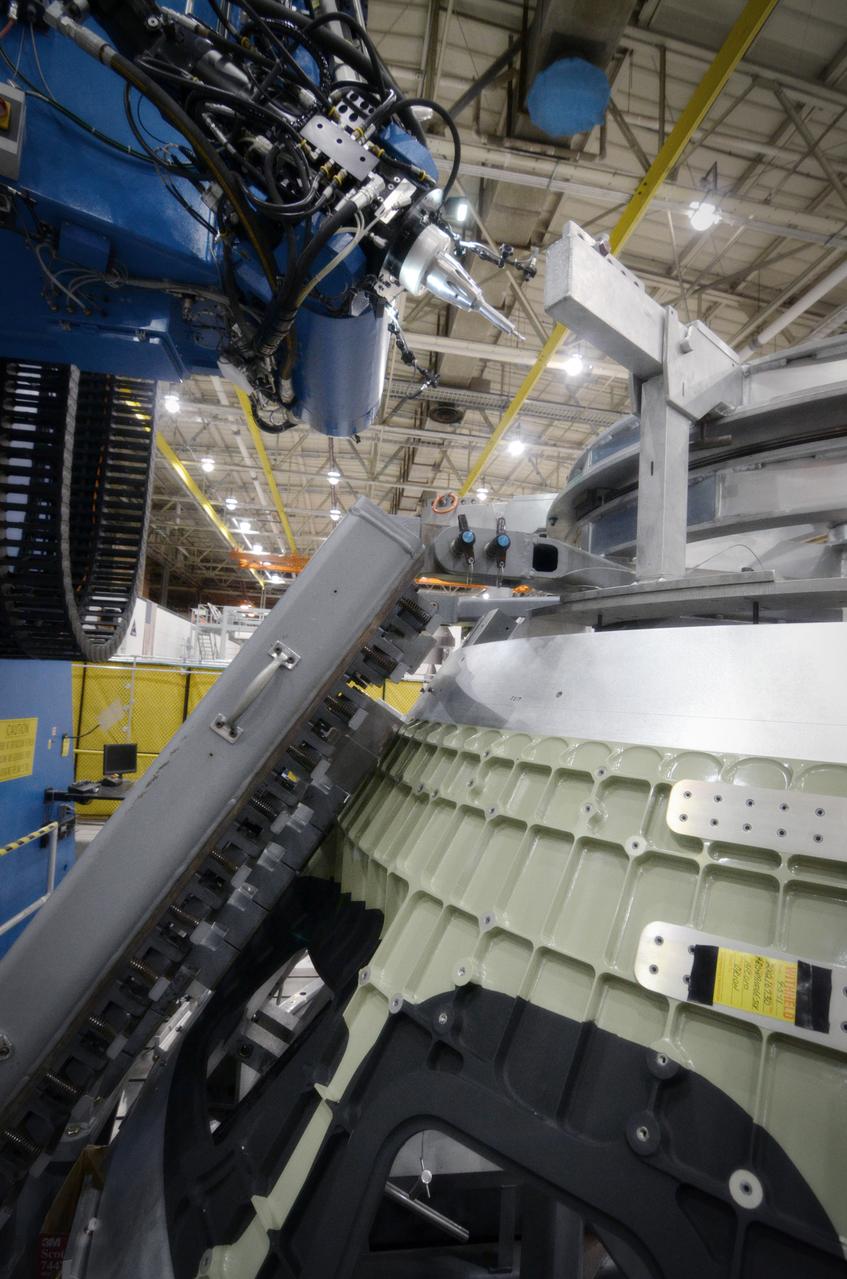 Technicians begin welding the Exploration Flight Test-1 (EFT-1) Orion pressure vessel at NASA’s Michoud Assembly Facility in New Orleans on Sept. 9, 2011. Orion’s pressure vessel is underlying frame of the crew module that will provide an air-tight, habitable space for astronauts on future missions to the Moon. Part of Batch image transfer from Flickr.