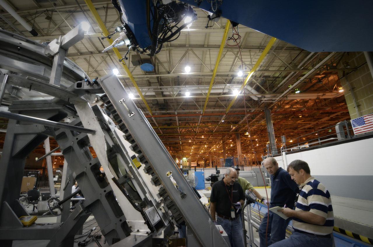 Technicians begin welding the Exploration Flight Test-1 (EFT-1) Orion pressure vessel at NASA’s Michoud Assembly Facility in New Orleans on Sept. 9, 2011. Orion’s pressure vessel is underlying frame of the crew module that will provide an air-tight, habitable space for astronauts on future missions to the Moon. Part of Batch image transfer from Flickr.