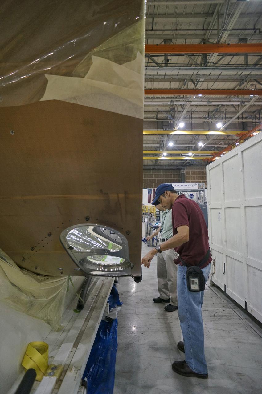 Lockheed Martin technicians work on a Exploration Flight Test-1 (EFT-1) spacecraft adapter jettison fairing at NASA's Michoud Assembly Facility in New Orleans on Nov. 10, 2011.  Part of Batch image transfer from Flickr. 