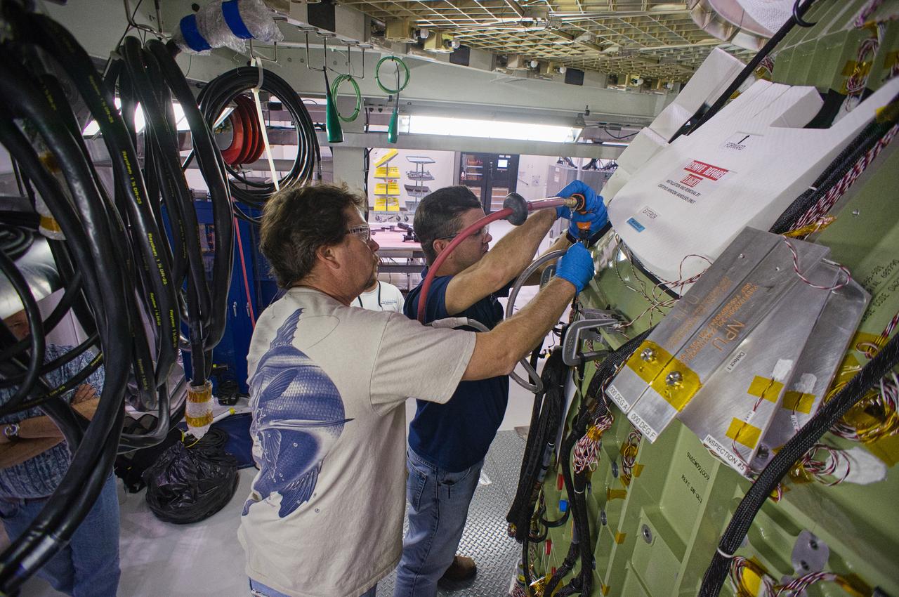 The Exploration Flight Test-1 (EFT-1) Orion crew module undergoes assembly operations in the Operations and Checkout (O&amp;C) Building at NASA’s Kennedy Space Center on Jan. 1, 2012. Part of Batch image transfer from Flickr. 