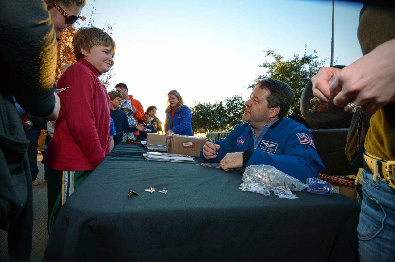 Astronaut Nicholas Patrick signs autographs for visitors during Orion Pad Abort-1 pathfinder display at an event outside American Airlines Center in Dallas on Jan. 27, 2012. Part of Batch image transfer from Flickr.