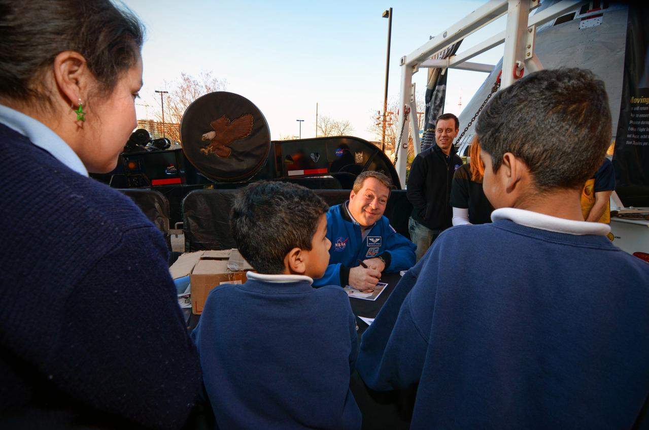 Astronaut Nicholas Patrick signs autographs for visitors during Orion Pad Abort-1 pathfinder display at an event outside American Airlines Center in Dallas on Jan. 27, 2012. Part of Batch image transfer from Flickr.