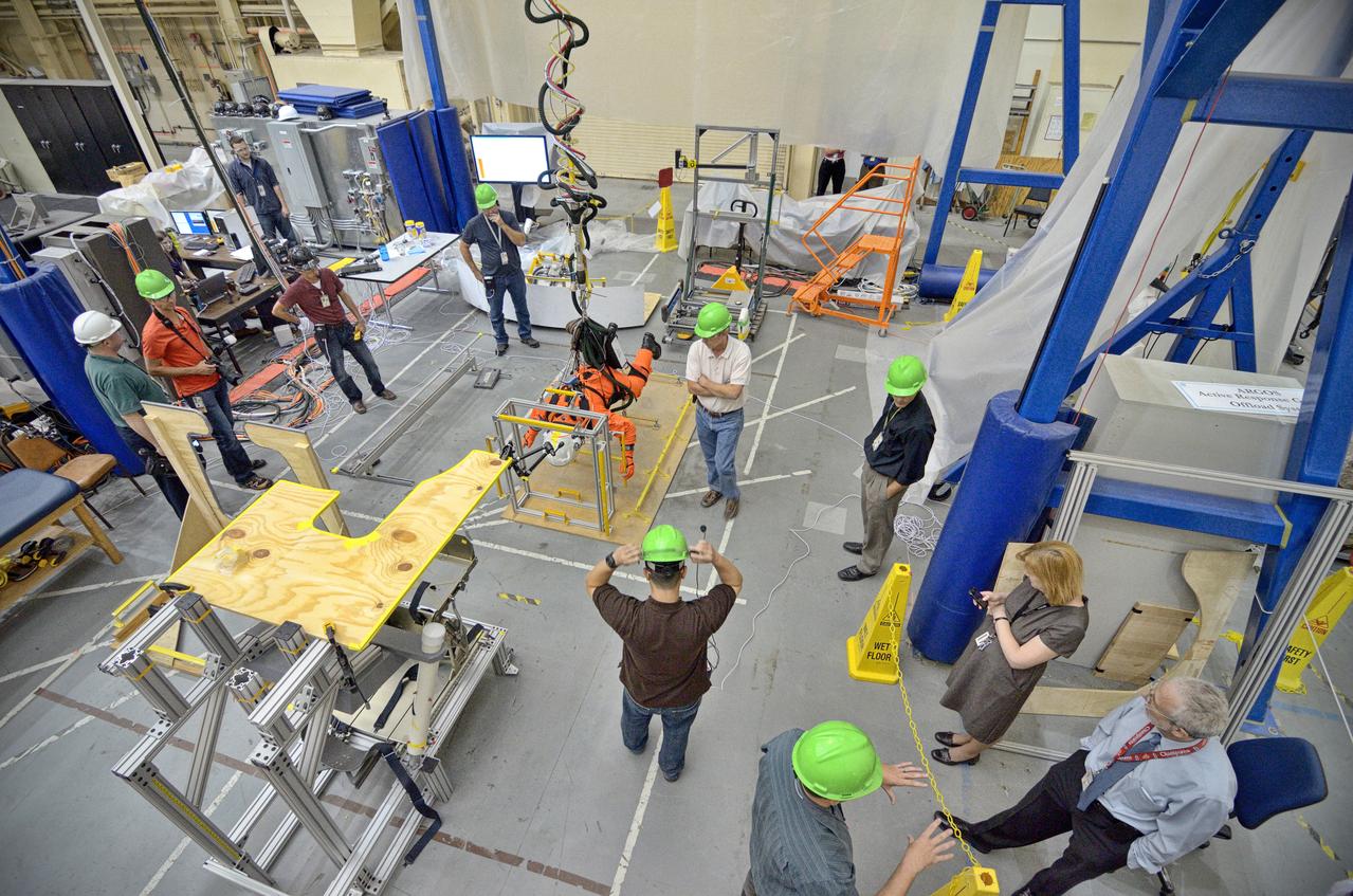 Astronaut Rex Walheim uses the Active Response Gravity Offload System (ARGOS) to perform early evaluations of the Orion Crew Survival System (OCSS) suit in Building 9 of Johnson Space Center in Houston on June 5, 2012. ARGOS is designed to simulate reduced gravity environments, such as lunar, Martian, or microgravity, using a system similar to an overhead bridge crane. Part of Batch image transfer from Flickr.
