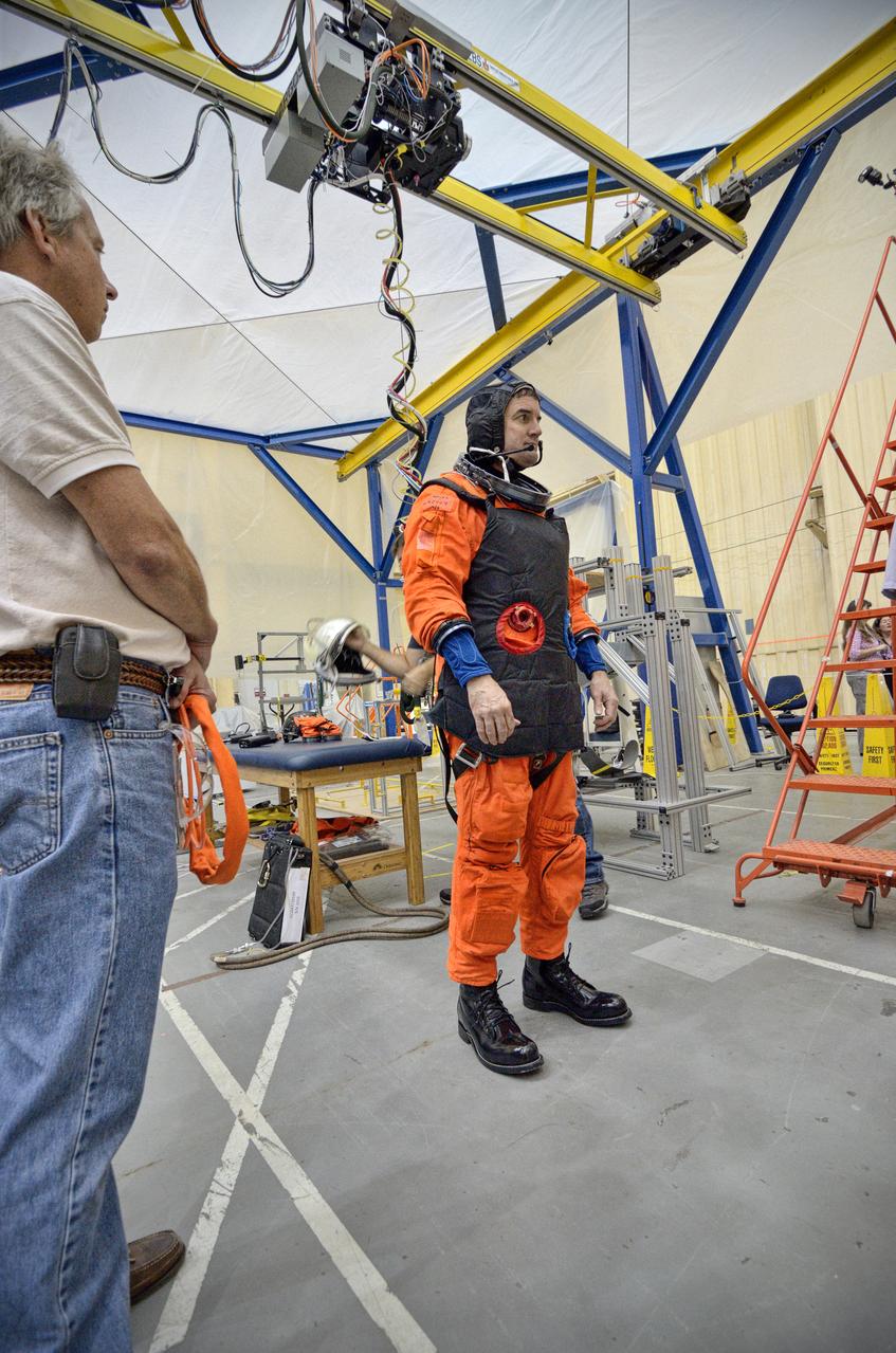 Astronaut Rex Walheim uses the Active Response Gravity Offload System (ARGOS) to perform early evaluations of the Orion Crew Survival System (OCSS) suit in Building 9 of Johnson Space Center in Houston on June 5, 2012. ARGOS is designed to simulate reduced gravity environments, such as lunar, Martian, or microgravity, using a system similar to an overhead bridge crane. Part of Batch image transfer from Flickr.