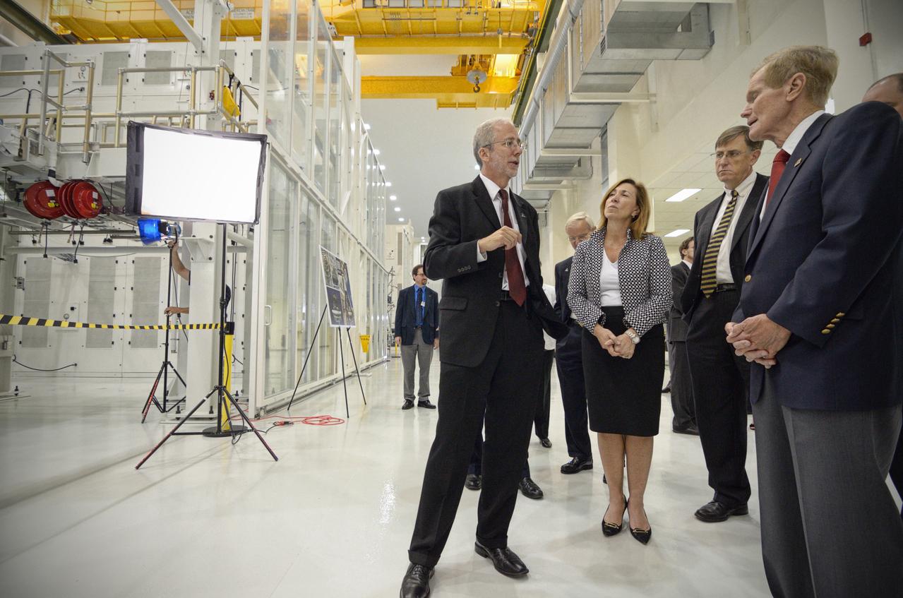 The Orion crew module pressure vessel for Exploration Flight Test-1 (EFT-1) is unveiled at a ceremony at the Operations and Checkout (O&amp;C) Building at NASA’s Kennedy Space Center in Florida on July 2, 2012. Orion Program Manager Mark Geyer is visible talking to others. Part of Batch image transfer from Flickr. 