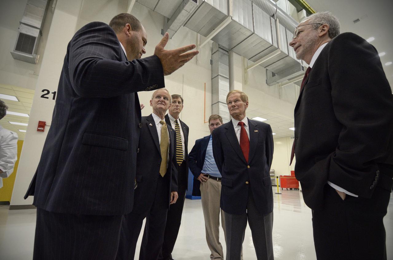 The Orion crew module pressure vessel for Exploration Flight Test-1 (EFT-1) is unveiled at a ceremony at the Operations and Checkout (O&amp;C) Building at NASA’s Kennedy Space Center in Florida on July 2, 2012. Orion Program Manager Mark Geyer is visible talking to others. Part of Batch image transfer from Flickr. 